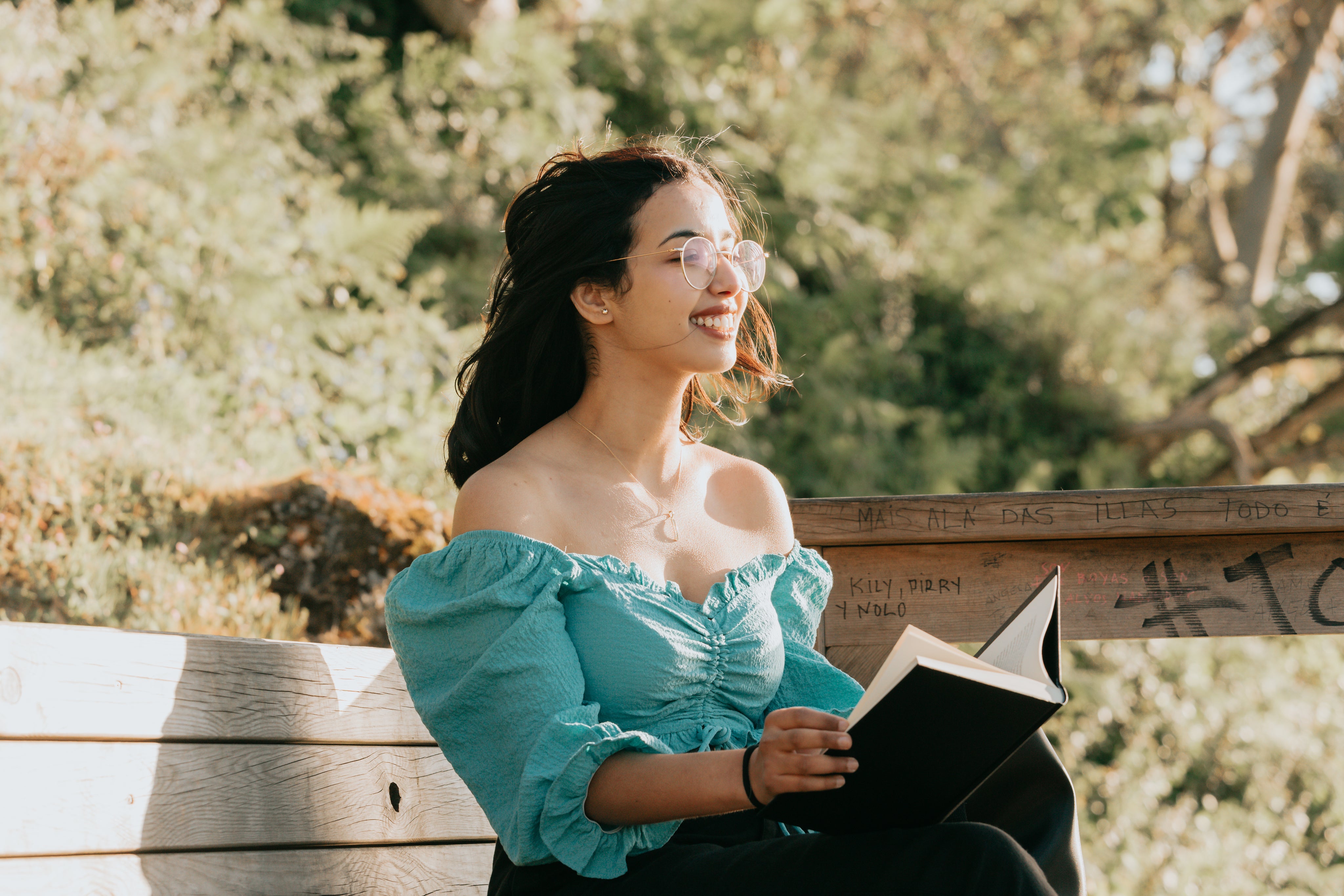 woman on bench reading a book
